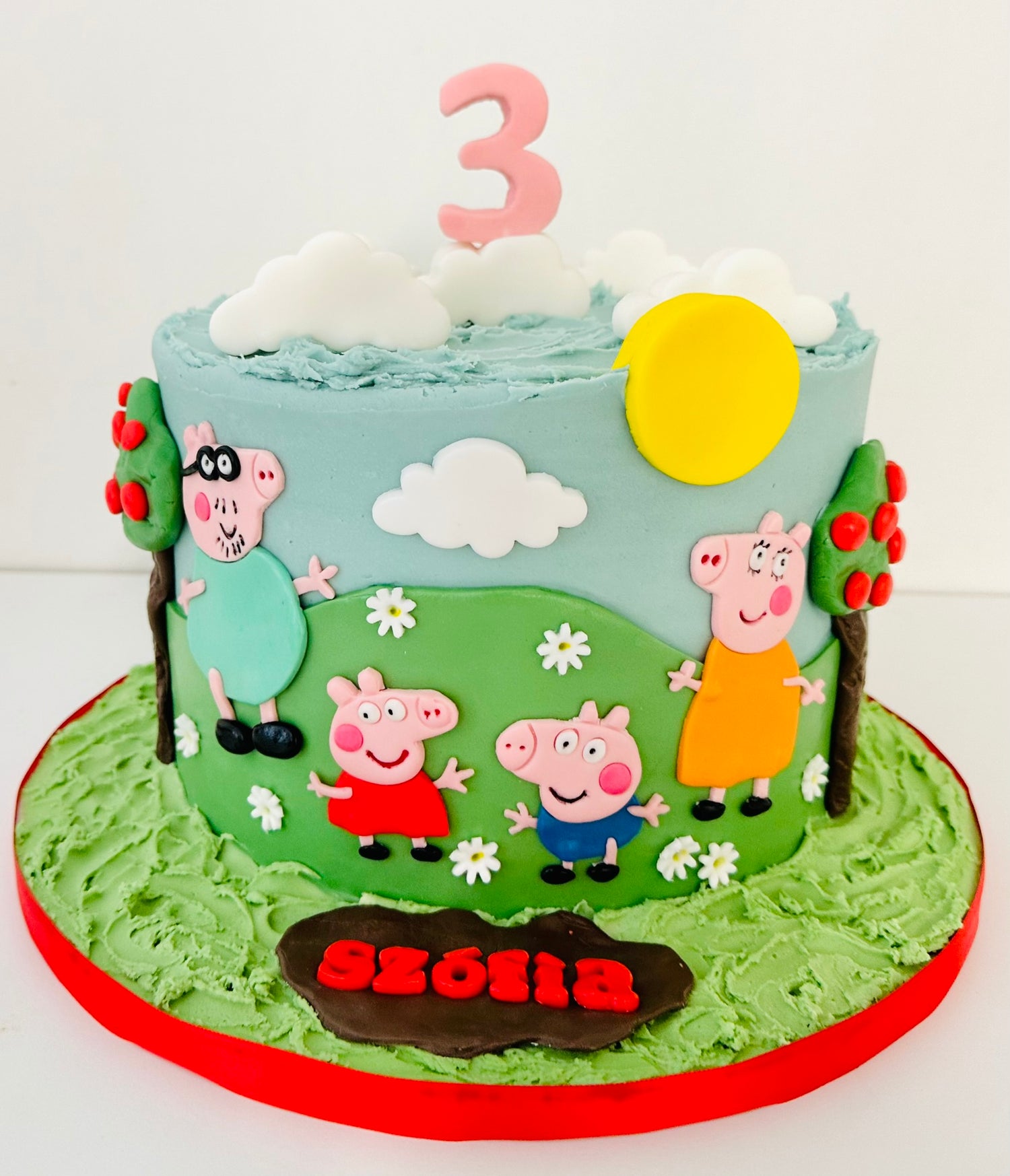 Peppa pig birthday cake with all four characters on the hill