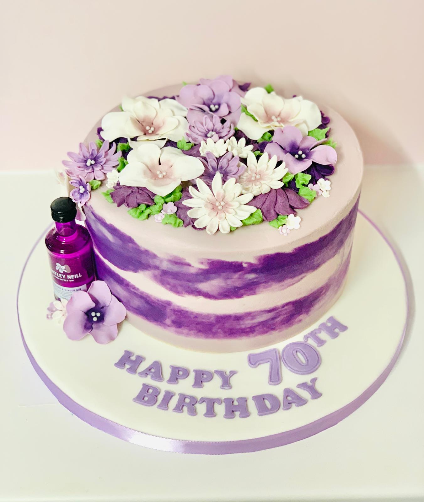 Purple  birthday cake with sugar paste flowers with mini Gin bottle